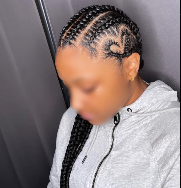a girl showing her heart braids from front, face blurred