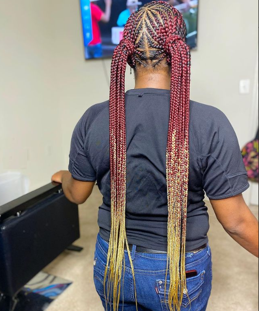 Ombre burgundy and blonde knotless braids shown from back